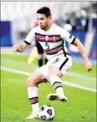  ?? AFP ?? Portugal defender Raphael Guerreiro handles the ball in a scoreless draw against France that left the team in its first-place position.