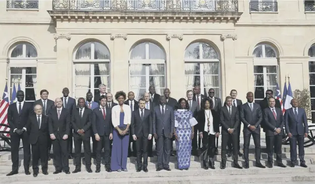  ?? PICTURE; STEPHANE MAHE/AFP/GETTY IM,AGES ?? 0 Emmanuel Macron with Liberia’s president George Weah and his wife Clar and lunch guests at the Elysee Palace, in Paris yesterday