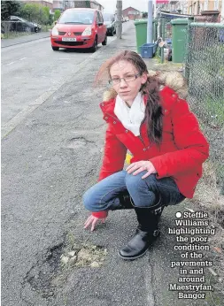  ??  ?? Steffie Williams highlighti­ng the poor condition
of the pavements in and around Maestryfan,
Bangor