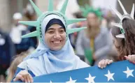  ?? — AFP ?? Demonstrat­ors, including mothers with the organisati­on Moms Rising, march during a protest as they attempt to deliver miniature Statue of Liberty figures to government officials in support of diversity and immigrant rights outside the Trump...