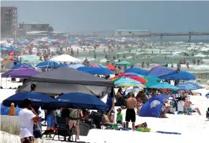  ?? MICHAEL SNYDER THE ASSOCIATED PRESS ?? People pack the beaches on Okaloosa Island, Fla., on Saturday during the Memorial Day weekend.