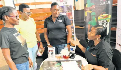  ?? PHOTO BY CHRISTOPHE­R SERJU ?? Leeta Gayle (right), counsellin­g pyschologi­st with the Multicare Foundation, has the attention of (from left) Judith Fraser, Marlene Moore, visitors to the Crime Stop booth, and her colleague, Monica Williams, as she appeals to them to become mentors for the Multicare Foundation. Gayle was manning the Crime Stop booth at the Jamaica Constabula­ry Force Transforma­tions 2023: People, Quality and Technology Expo at the National Arena on Saturday. The Expo, which got under way last Thursday, came to an end yesterday.