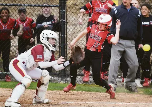  ?? Brian A. Pounds / Hearst Connecticu­t Media ?? Masuk’s Angela King scores ahead of the tag by St. Joseph catcher Kelsea Flanagan to give her team a 1-0 lead in the third inning on Thursday in Trumbull.