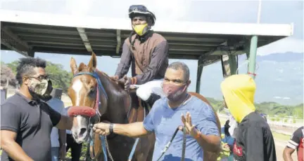  ??  ?? Trainer Robert Darby (second right) celebrates his 400th winner, Papa Albert. The jockey is Omar Walker. At left is trainer Steven Todd.