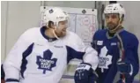  ?? RICHARD LAUTENS/TORONTO STAR ?? Leafs winger Phil Kessel, left, gives Nazem Kadri a playful elbow during practice on Thursday.