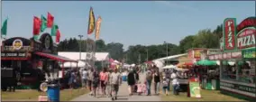  ?? LAUREN HALLIGAN - MEDIANEWS GROUP ?? Eventgoers stroll through the Saratoga County Fairground­s for the sixth annual Saratoga Balloon and BBQ Festival.