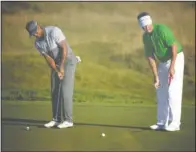  ?? The Associated Press ?? PUTTING GREEN: Past tournament winners Tiger Woods, left, and Davis Love III putt on the first green during a practice round for the PGA Championsh­ip Tuesday at Whistling Straits in Haven, Wis. Woods’ 14 major titles include four in the PGA...