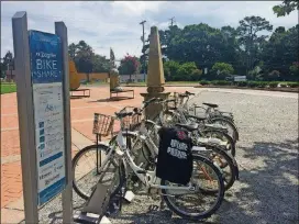  ?? JILL VEJNOSKA / JVEJNOSKA@AJC.COM ?? A bike share station at Town Center Park, one of two locations where people can pick up and drop off rented bikes in Suwanee. By joining the bike share program, the first three hours to ride are free, a boon in a city that continues to build a bigger and more connecting network of parks and trails.