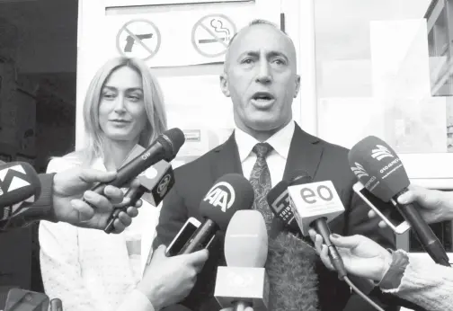  ??  ?? HARADINAJ, calon untuk jawatan perdana menteri dari pakatan komandan AAK, PDK dan NISMA bagi bekas Tentera Pembebasan Kosovo (KLA), bercakap di hadapan media selepas membuang undi bersama isterinya di Pristina, semalam. — Gambar Reuters