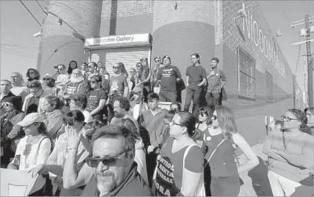  ?? Photograph­s by Genaro Molina Los Angeles Times ?? MEMBERS of the Boyle Heights Alliance Against Artwashing and Displaceme­nt gather Saturday outside Nicodim Gallery.