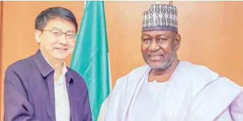  ?? ?? Minister of Power, Engr. Abubakar D. Aliyu (right) when he received on courtesy visit, a delegation from China Renewable Energy Engineerin­g Institute led by the Deputy Director General of the institute Mr. Gu Hongbin (left) in his office in Abuja, recently