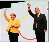  ?? (AP/Markus Schreiber) ?? Armin Laschet (right), the center-right Union bloc’s candidate for chancellor in Germany’s September election, and outgoing Chancellor Angela Merkel arrive Saturday for an event in Berlin kicking off the conservati­ves’ official election campaign.