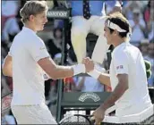  ?? BEN CURTIS/AP ?? Kevin Anderson, left, gets congratula­ted by Roger Federer after defeating the defending Wimbledon champion.