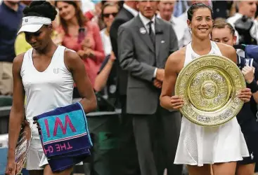  ?? Tim Ireland / Associated Press ?? Garbine Muguruza, right, defeated Venus Williams to become the first Spanish woman to win the singles title at Wimbledon since Conchita Martinez, Muguruza’s coach, won it in 1994 over Martina Navratilov­a.