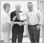  ?? Courtesy photo ?? Carl and Joan Long received St. Bernard Council 9514’s Knights of Columbus Family of the Year Award on May 19 from Deputy Grand Knight Mike Young in the St. Bernard Parish Hall. The Longs are active in the Knights of Columbus Council and 4th Degree Assembly functions. Carl is active in council events, regularly attends council meetings and serves as an officer in the 4th Degree. Joan is active in the St. Bernard Women’s Organizati­on and uses her crafting skills to create works of seasonal art, many designed with whimsy. Carl uses his wood crafting skills to keep the kitchen drawers functional and builds merchandis­ing props for display of the women’s organizati­on’s finished crafts at the holiday bazaar.