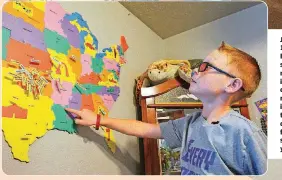  ??  ?? Jax Sealey, 11, from Butler, shows off the map marking every donation he received on it. He hopes to have a donation from every state this year.