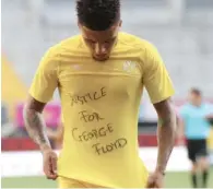  ?? (AFP) ?? Dortmund’s English midfielder Jadon Sancho shows a “Justice for George Floyd” shirt as he celebrates after scoring during the Bundesliga match against SC Paderborn 07 on Sunday.