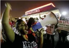  ?? DAVID GOLDMAN/THE ASSOCIATED PRESS ?? Carmen Burley-Rawls chants during a minimum-wage protest outside a Burger King restaurant in College Park, Ga., on Wednesday.