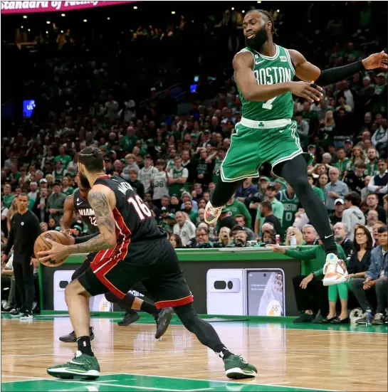  ?? MATT STONE — BOSTON HERALD ?? Miami’s Caleb Martin drives past Celtics forward Jaylen Brown after faking him during Game 7of the Eastern Conference Finals on Monday in Boston.