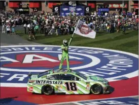  ?? RACHEL LUNA — THE ASSOCIATED PRESS ?? Kyle Busch stands on his car after winning the Monster Energy Cup Series race March 17 at Auto Club Speedway in Fontana, Calif.