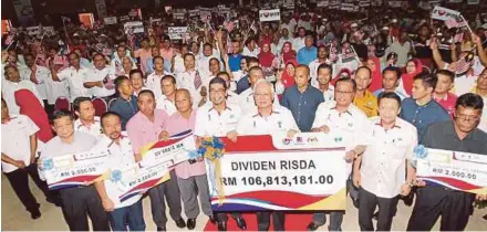  ?? PIC BY FARIZUL HAFIZ AWANG ?? Prime Minister Datuk Seri Najib Razak and Rural and Regional Developmen­t Minister Datuk Seri Ismail Sabri Yaakob (front row, third from right) with a mock cheque for RM106.8 million at a dividend payment event in Pekan yesterday.