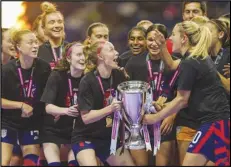  ?? Associated Press ?? United States players hold the trophy as they celebrate winning the CONCACAF Women’s Championsh­ip final soccer match against Canada on July 18 in Monterrey, Mexico.