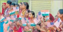  ?? PTI ?? Women display Indian and US flags to welcome US President Donald Trump on his arrival in Agra on Monday.