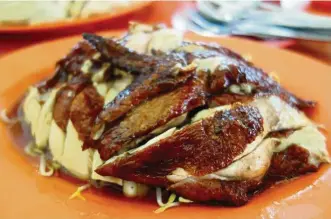  ??  ?? Shi Mei Restaurant’s roasted chicken rice has a beautiful, appetising brown skin and a marinade that permeates the meat.