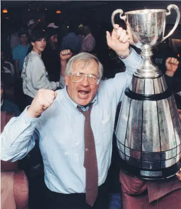  ??  ?? Roughrider­s head coach John Gregory celebrates with the Grey Cup in 1989.