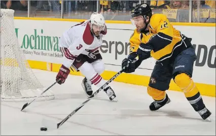  ?? — GETTY IMAGES PHOTOS ?? Predators centre Mike Fisher (right) tries to move past Coyotes defenceman Keith Yandle in Wednesday night’s Game 3 at Nashville, Tenn. Fisher scored his first goal of the 2012 playoffs.