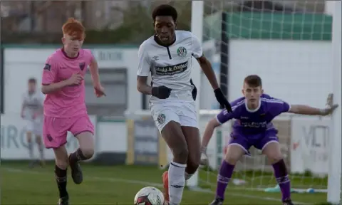  ??  ?? Destiny Idele of Bray Wanderers is closed down by Graham O’Reilly of Wexford F.C., with netminder Cian Browne alert at his near post.