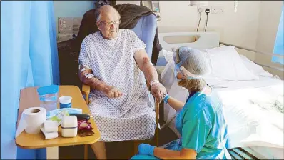  ?? AFP ?? Photo shows coronaviru­s patient George Gilbert, 85, at the Addenbrook­e hospital in England on Thursday. Gilbert is receiving a treatment called TACTIC-R, which tests whether existing drugs will help prevent the body’s immune system from overreacti­ng, which scientists hope could prevent organ failure and death in COVID-19 patients.