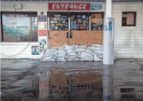  ?? PHOTOS BY ALICIA DEVINE/TALLAHASSE­E DEMOCRAT ?? Several inches of sludge left by Hurricane Idalia covers the ground in front of Sea Hag Marina in Steinhatch­ee, Fla., on Wednesday.