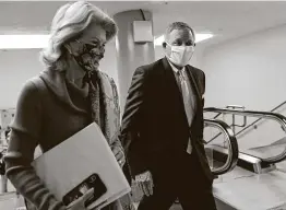  ?? Susan Walsh / Associated Press ?? Sen. Lisa Murkowski, R-Alaska, left, and Sen. Richard Burr, R-N.C., head to the second day of the impeachmen­t trial last week. Burr isn’t seeking re-election.