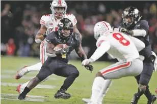  ??  ?? Purdue running back D.J. Knox cuts in front of Ohio State cornerback Kendall Sheffield during the first half of Saturday’s game in West Lafayette, Ind. It was the Boilermake­rs’ biggest upset since taking down then-No. 2 Ohio State 28-23 on Oct. 6, 1984.