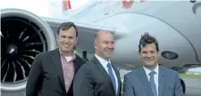  ?? CLEMENT SABOURIN/GETTY IMAGES ?? Fred Cromer (L), President of Bombardier Commercial Aircraft; Alain Bellemare (C), Bombardier CEO; and Pierre Beaudoin (R), Bombardier Executive Chairman of the Board, stand before a Bombardier CS100, in Mirabel, Quebec last year. The company is...