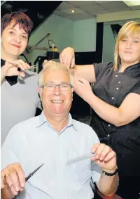  ??  ?? Razors Edge barbers shop owner retired Len Albon. He is pictured here with staff members Debbie McKeown and Claire Hodkinson