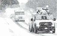  ?? Kin Man Hui / Staff photograph­er ?? CPS Energy trucks rumble along Vance Jackson Road during Winter Storm Uri, but the utility’s storm response was lacking.