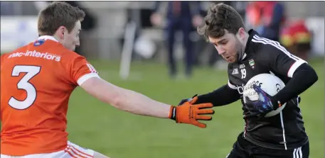  ??  ?? Sligo substitute Stephen Coen, who was awarded a penalty in the last minute, in action with Armagh’s Charlie Vernon. Pics: Carl Brennan