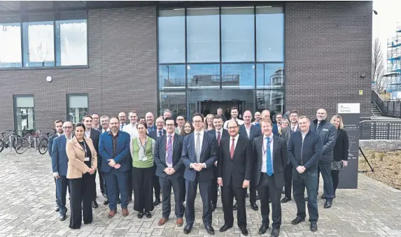  ?? ?? Cabinet Office minister Alex Burghart opens the Government Agency hub at Fletton Quays pictured with staff.