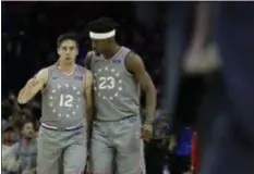  ?? MATT SLOCUM — THE ASSOCIATED PRESS ?? Fueled in part by the power of his headband, Jimmy Butler, right, and T.J. McConnell helped the Sixers take down the Wizards, 123-98 Friday.