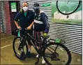  ?? COURTESY OF GOOD KARMA BIKES ?? Good Karma Bikes CEO Jim Gardner, left, poses with Norton, a homeless veteran, and the bike that was donated to him in July.