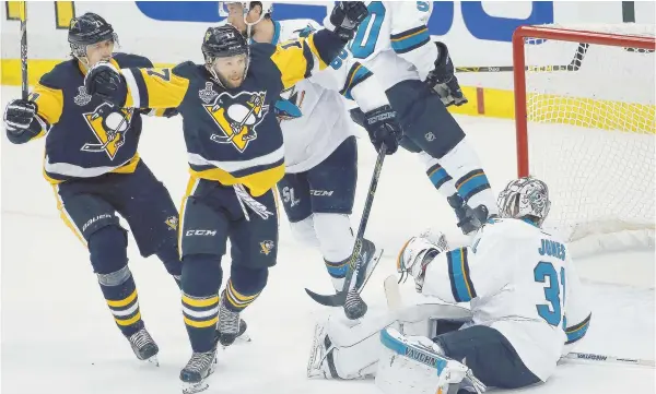  ?? AP PHOTO ?? FAST START: Bryan Rust (17) celebrates after scoring on Martin Jones (31) during the Penguins’ 3-2 victory against the San Jose Sharks in Game 1 of the Stanley Cup finals last night in Pittsburgh.