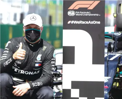  ??  ?? Mercedes driver Valtteri Bottas of Finland, wearing a mask against the spread of the coronaviru­s. He went on to win pole position for today’s season-opening race in Austria. Photo: AP