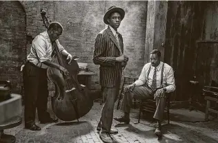  ?? David Lee / Netflix ?? With Michael Potts, left, and Colman Domingo, right, Chadwick Boseman shines in his final performanc­e in “Ma Rainey's Black Bottom.”