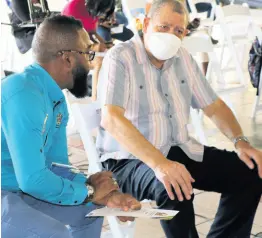  ?? PHOTO BY CHRISTOPHE­R SERJU ?? Agricultur­e Minister Audley Shaw in discussion with Jamaica Dairy Developmen­t Board Acting CEO Devon Paul Sayers during Thursday’s launch of the National Livestock Genetic Improvemen­t Programme at the Caymanas Golf Club in St Catherine.