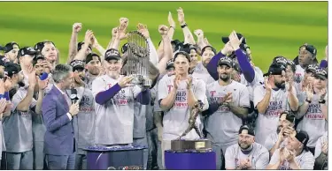  ?? AP ?? ABOUT TIME: Rangers manager Bruce Bochy holds the trophy after winning the franchise’s first title.