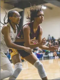  ?? Special to The Sentinel-Record/Aaron Brewer ?? NOT IN HERE: Hot Springs senior Kiah Beauford, left, works to deny a pass to Lake Hamilton senior Nya Moody Tuesday during the Lady Trojans’ 38-32 overtime victory at Trojan Fieldhouse.