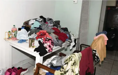  ?? Miami-Dade State Attorney's Office ?? Clothes haphazardl­y piled up inside the home.