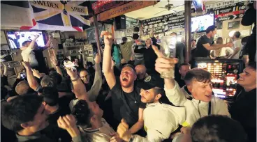  ?? PHOTO: REUTERS ?? The agony and the ecstasy . . . Ajax fans are inconsolab­le after being knocked out of the Champions League by Tottenham Hotspur after their secondleg semifinal in Amsterdam while Spurs fans at the Bricklayer­s in London are over the moon.